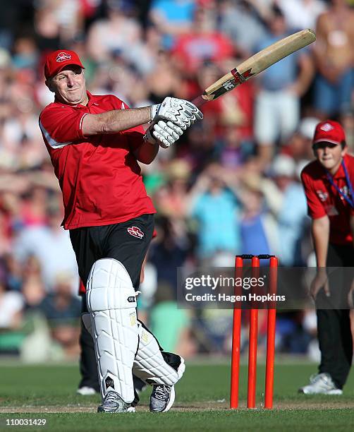 New Zealand Prime Minister John Key hits a four off the bowling of Shane Warne in their one on one challenge during the Christchurch Earthquake...