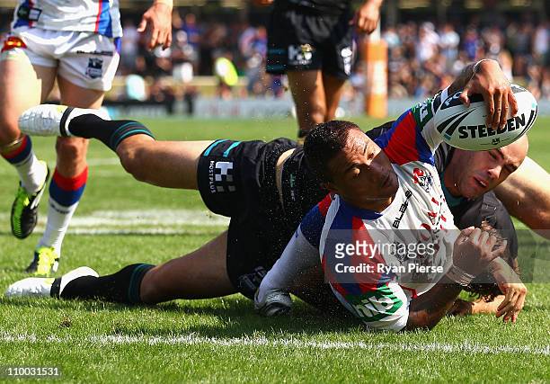Junior Sau of the Knights crosses to score a try during the round one NRL match between the Penrith Panthers and the Newcastle Knights at Centrebet...