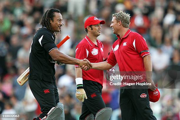 Tana Umaga and Shane Warne shake hands at the conclusion of the Christchurch Earthquake Relief Charity Twenty20 match at Basin Reserve on March 13,...