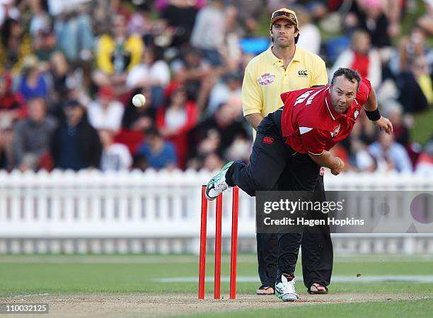 Craig McMillan bowls as Conrad Smith looks on during the Christchurch Earthquake Relief Charity Twenty20 match at Basin Reserve on March 13, 2011 in...