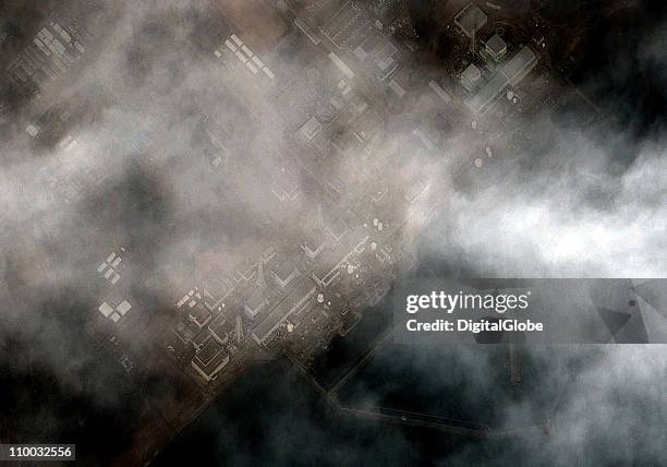 In this satellite view, damage caused by an explosion in the building housing reactor 1 at the Fukushima I Dai Ichi Nuclear Power plant can be seen...