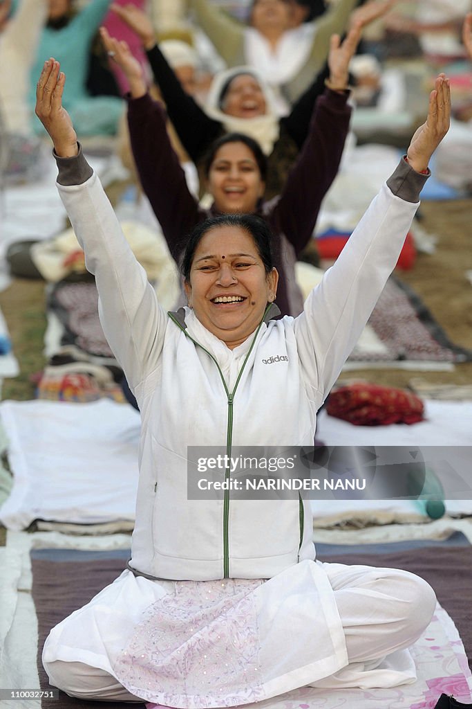 Indian attendees perform yoga exercises