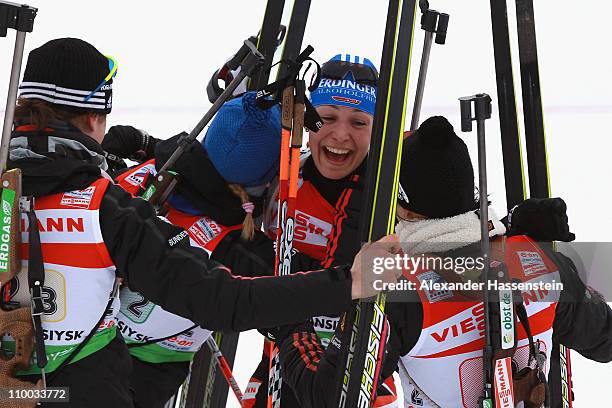 Magdalena Neuner of Germany celebrates winning the gold medal with her team mates Andera Henkel , Miriam Goessner and Tina Bachmann at the finish...