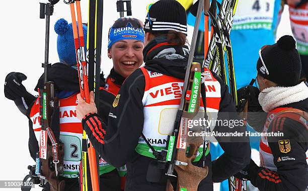 Magdalena Neuner of Germany celebrates winning the gold medal with her team mates Andrea Henkel , Miriam Goessner and Tina Bachmann at the finish...