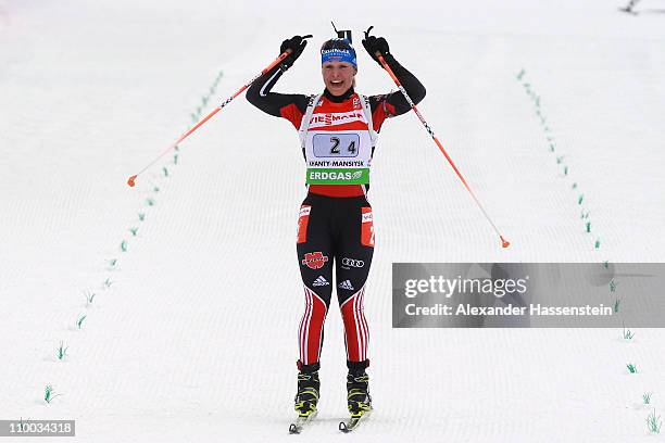 Magdalena Neuner of Germany celebrates winning the gold medal at the finish area of the women's relay during the IBU Biathlon World Championships at...