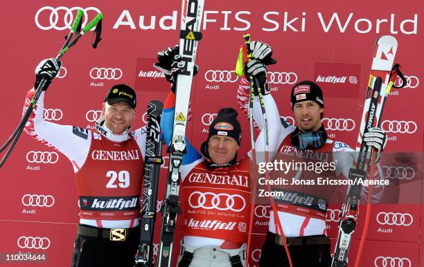 Didier Cuche of Switzerland takes 1st place, Klaus Kroell of Austria takes 2nd place, Joachim Puchner of Austria takes 3rd place during the Audi FIS...