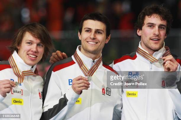 Denny Morrison, Lucas Makowsky and Mathieu Giroux of Canada take place on the podium for second place of the mens Team Persuit race during Day 4 of...