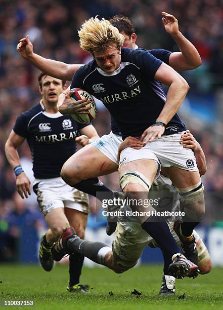 Richie Gray of Scotland is tackled by Louis Deacon of England during the RBS 6 Nations Championship match between England and Scotland at Twickenham...