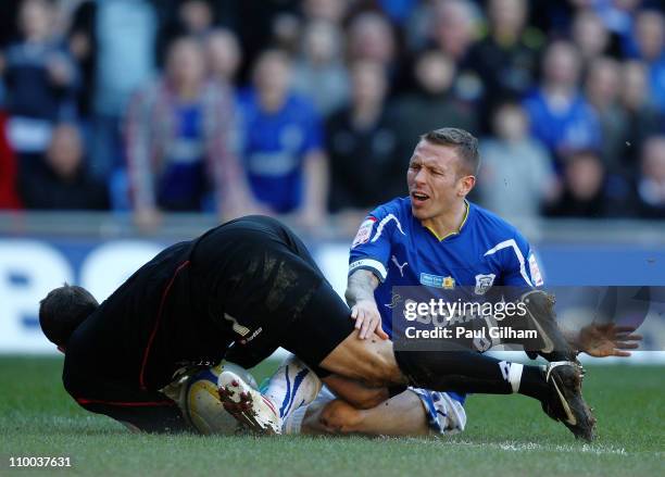 Craig Bellamy of Cardiff City battles for the ball with Luke Steele of Barnsley during the npower Championship match between Cardiff City and...