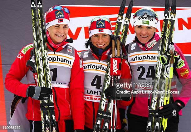 Astrid Jacobsen of Norway, Marit Bjoergen of Norway and Petra Majdic of Slovenia pose on the podium after the women's individual sprint of the FIS...
