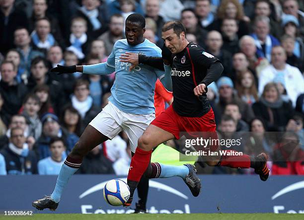 Yaya Toure of Manchester City and Zurab Khizanishvili of Reading battle for the ball during the FA Cup sponsored by E.On Sixth Round match between...