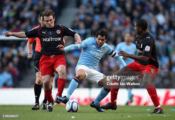 Carlos Tevez of Manchester City attempts to break through the Reading defence during the FA Cup sponsored by E.On Sixth Round match between...