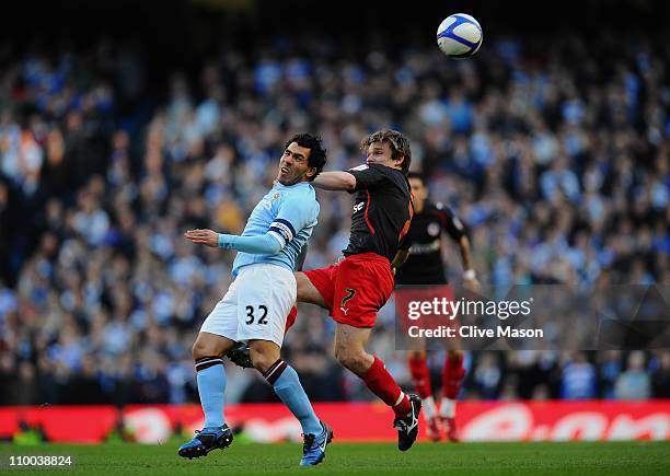 Carlos Tevez of Manchester City and Jay Tabb of Reading battle for the ball during the FA Cup sponsored by E.On Sixth Round match between Manchester...