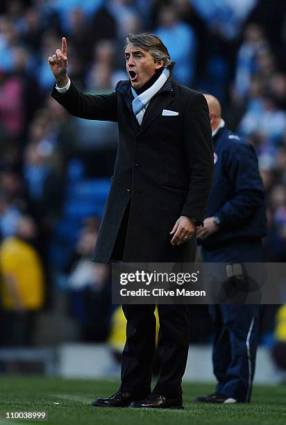 Manchester City manager Roberto Mancini shouts orders to his team during the FA Cup sponsored by E.On Sixth Round match between Manchester City and...