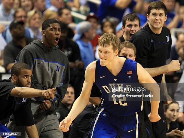 Kyle Singler of the Duke Blue Devils reacts as teammate Kyrie Irving and the bench cheer him on during the second half of the game against the North...