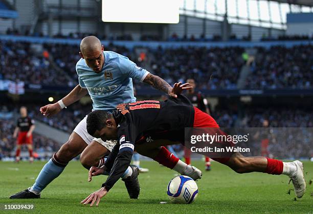 Jobi McAnuff of Reading falls under the challenge by Nigel De Jong of Manchester City during the FA Cup sponsored by E.On Sixth Round match between...