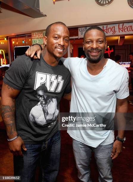 Player Willis McGahee of the Baltimore Ravens and DJ Irie attend the grand opening of Brother Jimmy's BBQ on March 12, 2011 in St Maarten,...