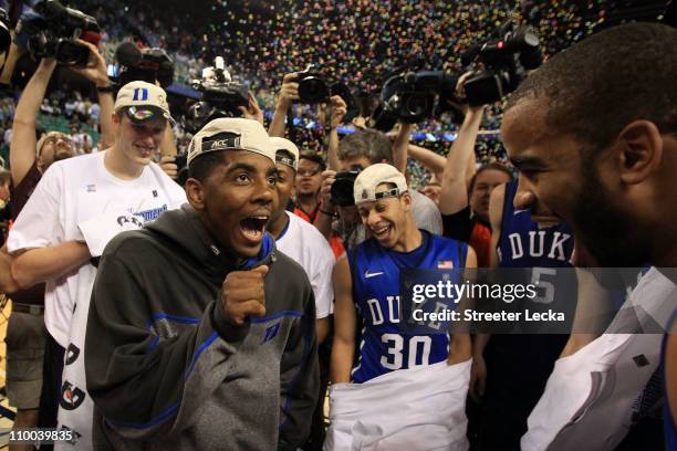 Kyrie Irving of the Duke Blue Devils celebrates with teammates after their 75-58 victory over the North Carolina Tar Heels to win the championship...