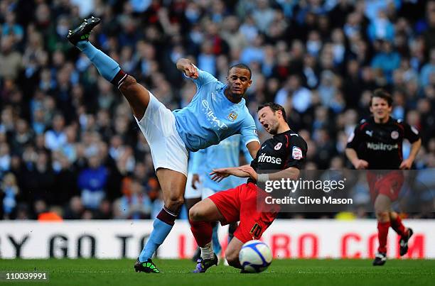 Vincent Kompany of Manchester City tackles Noel Hunt of Reading during the FA Cup sponsored by E.On Sixth Round match between Manchester City and...
