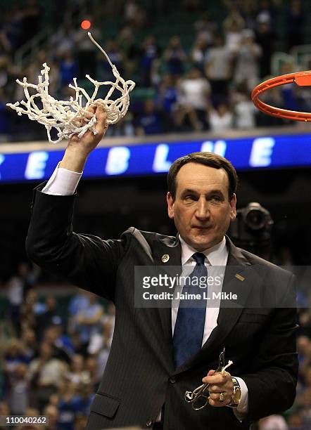 Head coach Mike Krzyzewski of the Duke Blue Devils cuts down the net after defeating the North Carolina Tar Heels 75-58 in the championship game of...
