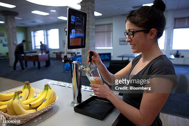 Kristen Whisenand, an employee of Yelp. Inc., pours a Hoegaarden beer at the Yelp Inc.'s office in San Francisco, California, U.S., on Monday, March...