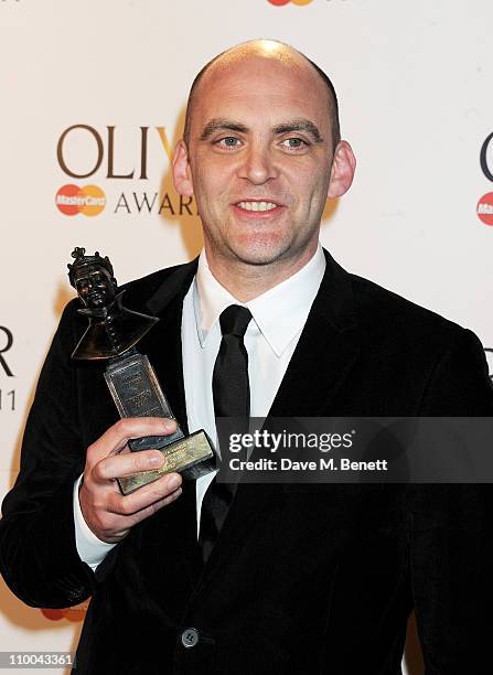 Artistic Director of London's Lyric Hammersmith Sean Holmes poses in the winner's room with the award for Outstanding Achievement in an Affiliate...