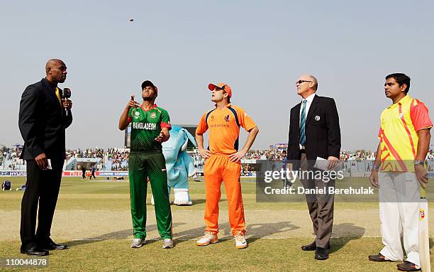 Captain Shakib Al Hasan of Bangladesh tosses the coin as captain Peter Borren of the Netherlands looks on ahead of the 2011 ICC Cricket World Cup...