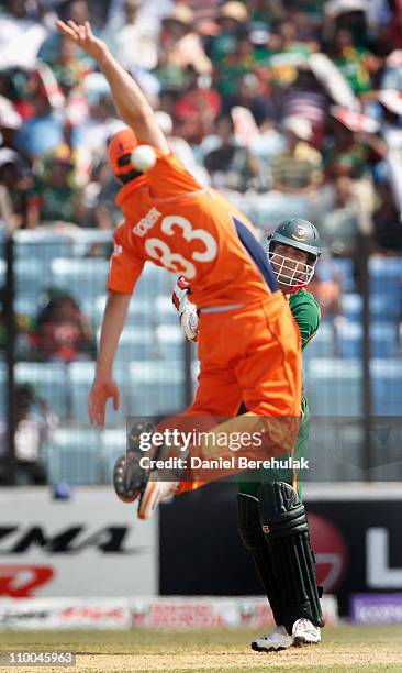 Zunaed Siddique of Bangladesh drives as captain Peter Borren of the Netherlands attempts to field the ball during the 2011 ICC Cricket World Cup...