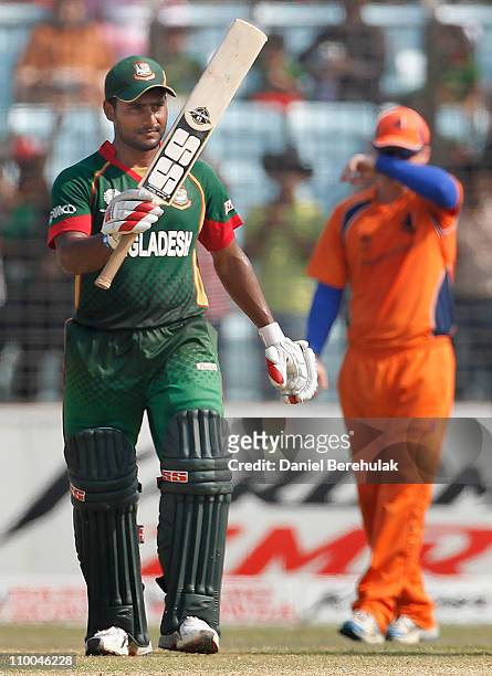 Imrul Kayes of Bangladesh raises his bat on scoring his half century during the 2011 ICC Cricket World Cup group B match between Bangladesh and the...