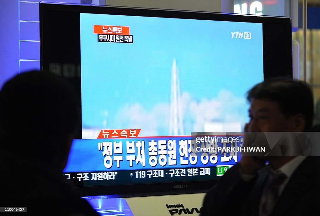 South Korean passengers watch TV showing