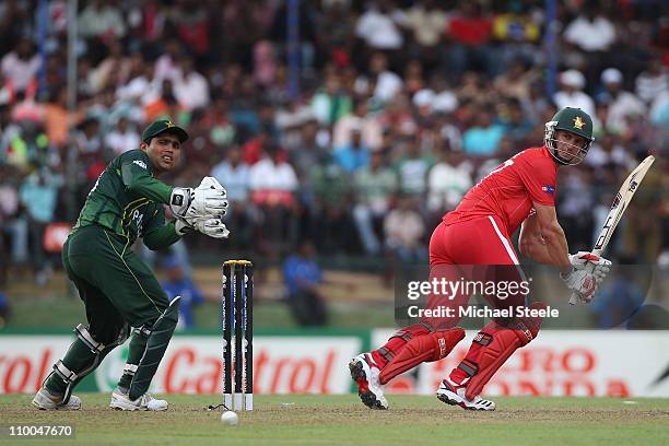 Craig Ervine of Zimbabwe plays fine to the legside as wicketkeeper Kamran Akmal looks on during the Pakistan v Zimbabwe 2011 ICC World Cup Group A...