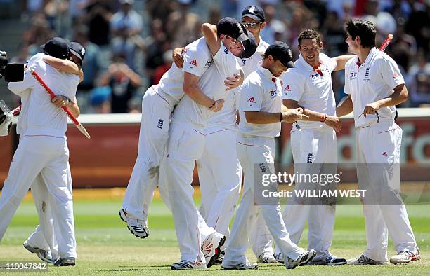 The England team celebrates after defeating Australia on the fourth day of the fourth Ashes cricket Test match, in Melbourne on December 29, 2010....