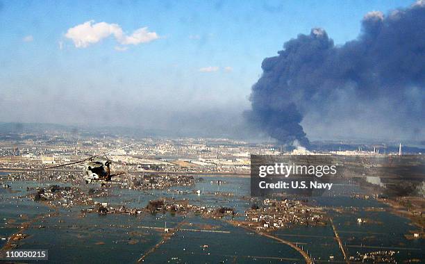 In this handout image provided by U.S. Navy, an aerial view of tsunami and earthquake damage is seen from an SH-60B helicopter assigned to the...