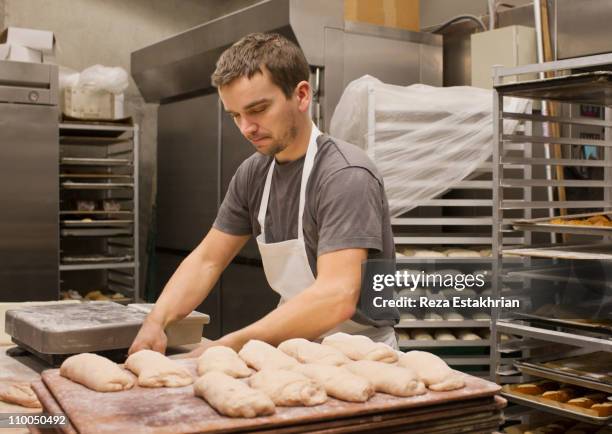 baker preparing bread - bakery apron bildbanksfoton och bilder