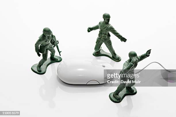 3 army toy army men and computer mouse - toy soldier stock pictures, royalty-free photos & images