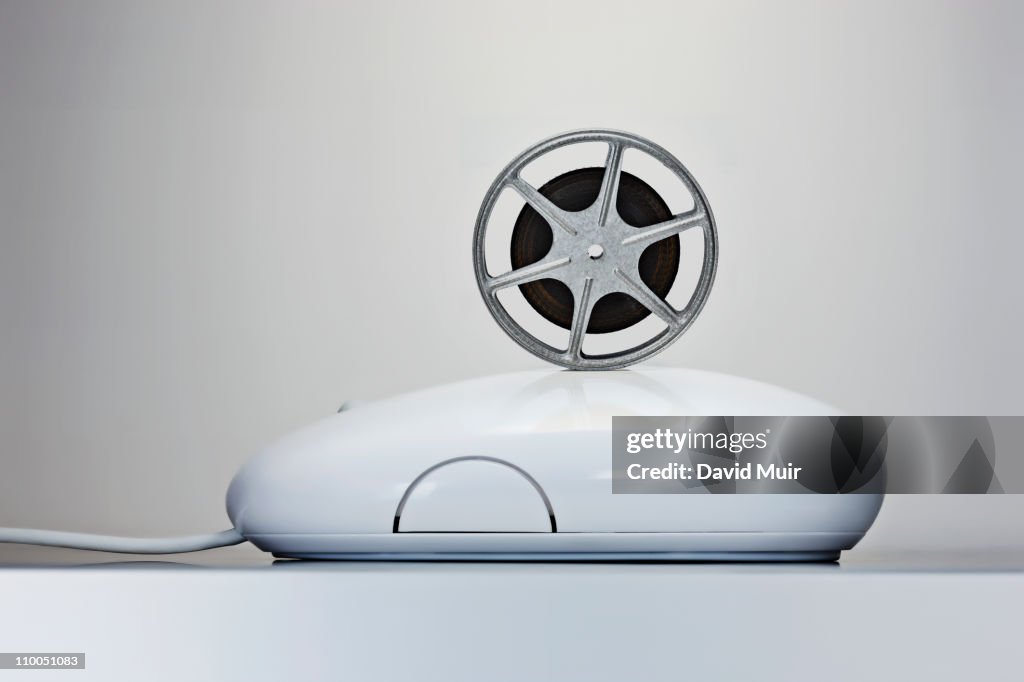 Movie film reel on a computer mouse