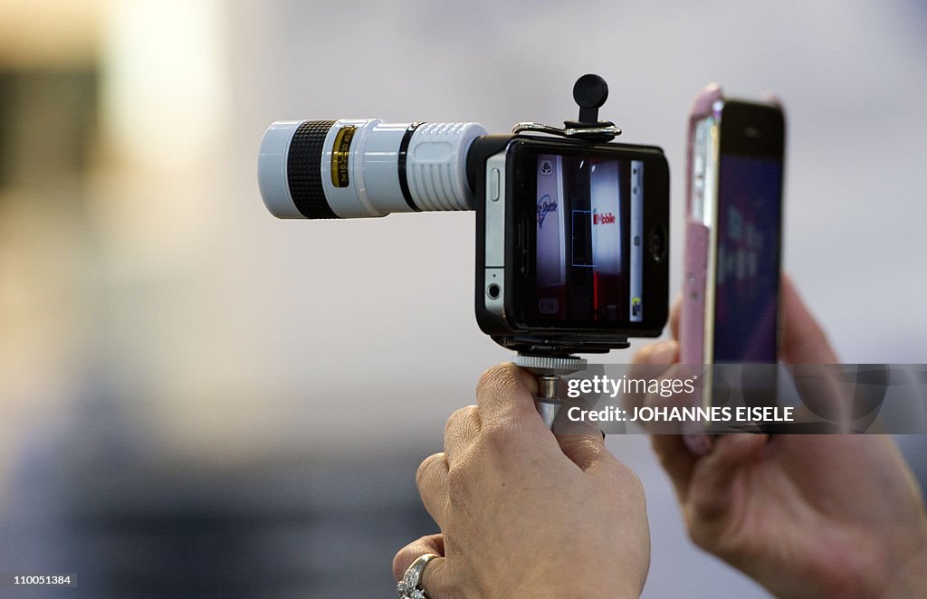 A woman displays a tele adapter for the