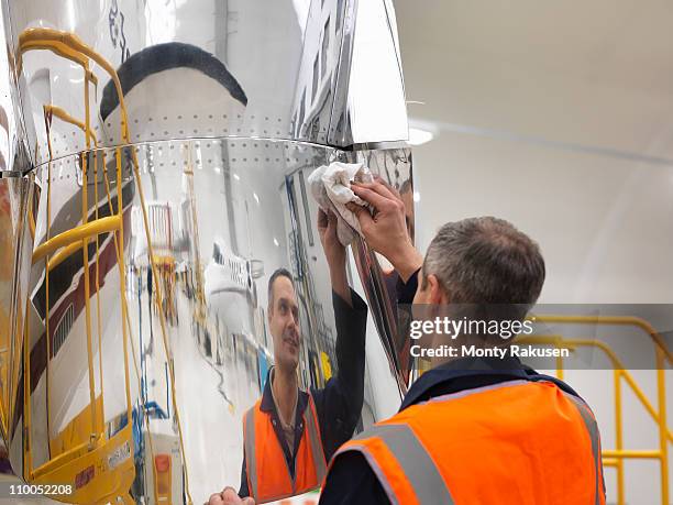 engineer works on jet aircraft - flugzeugmechaniker stock-fotos und bilder