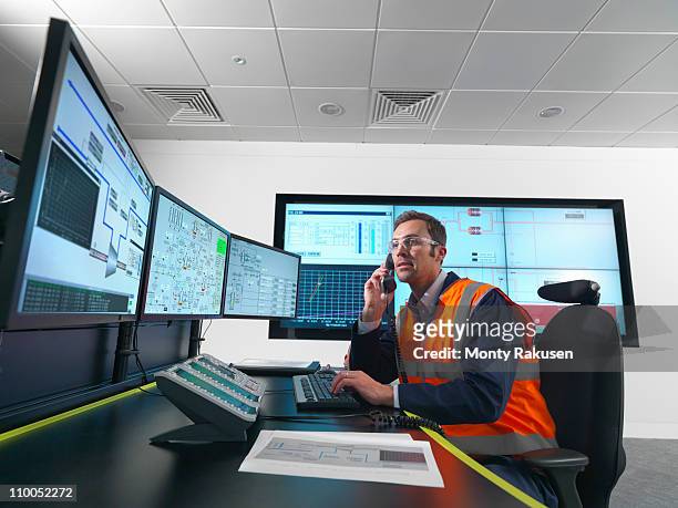 worker in control room with screens - telecoms engineer stock pictures, royalty-free photos & images
