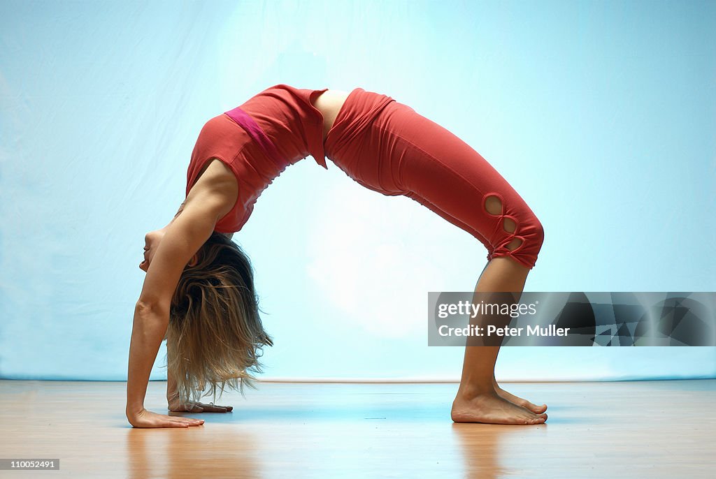 Lady doing yoga in a studio