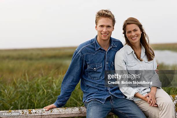 waiting at side of road - young couple stockfoto's en -beelden