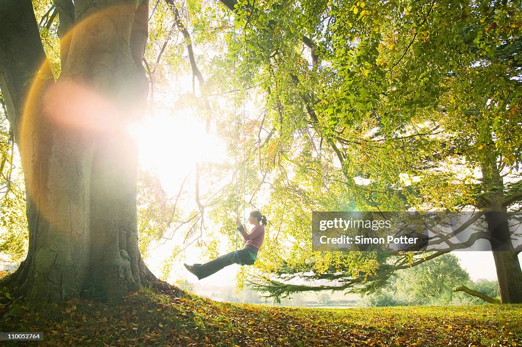 Girl on swing in sun