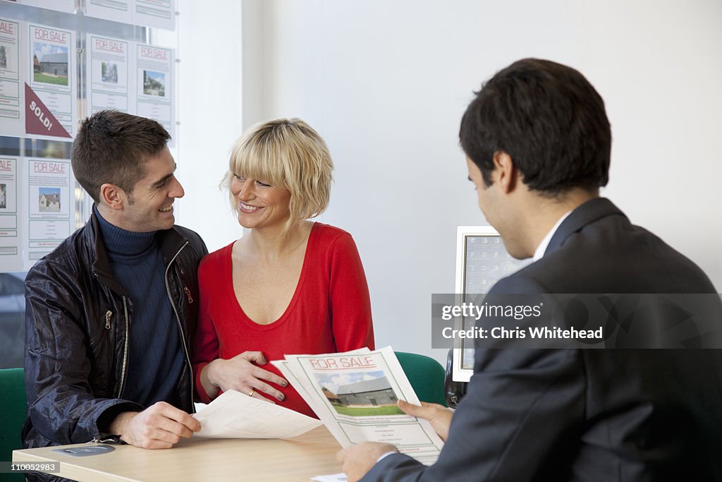 Couple visiting estate agents office