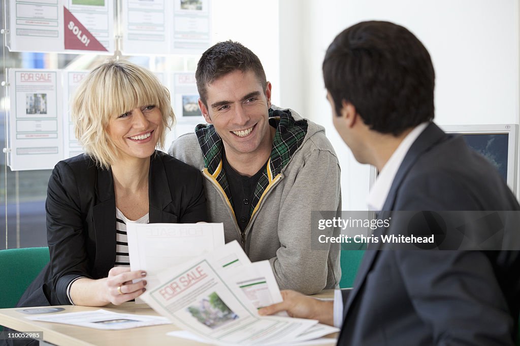 Couple visiting estate agents office