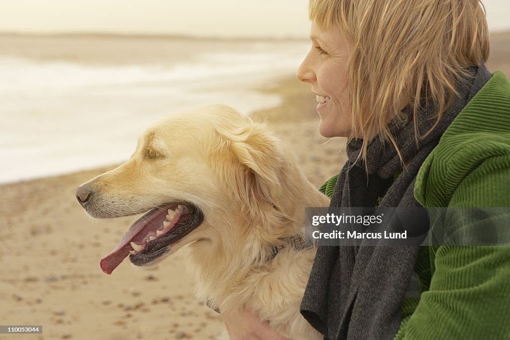 Woman and dog on beach