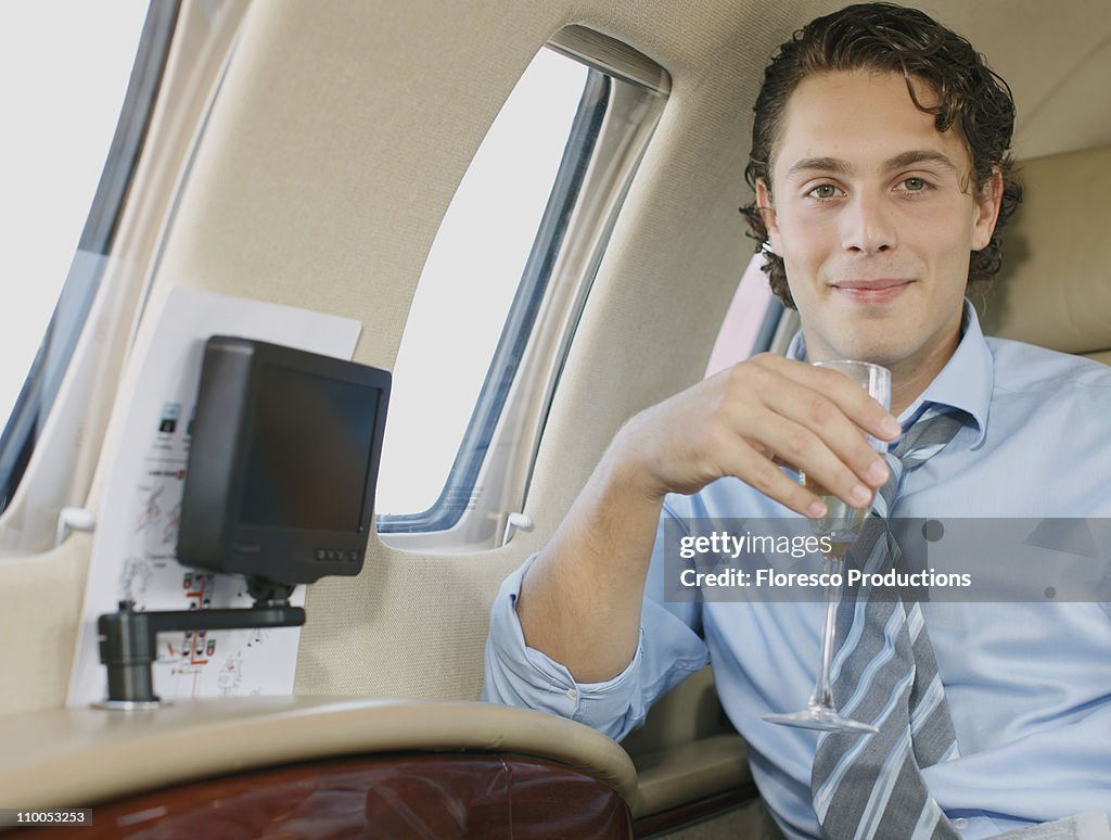 Smiling businessman in private jet