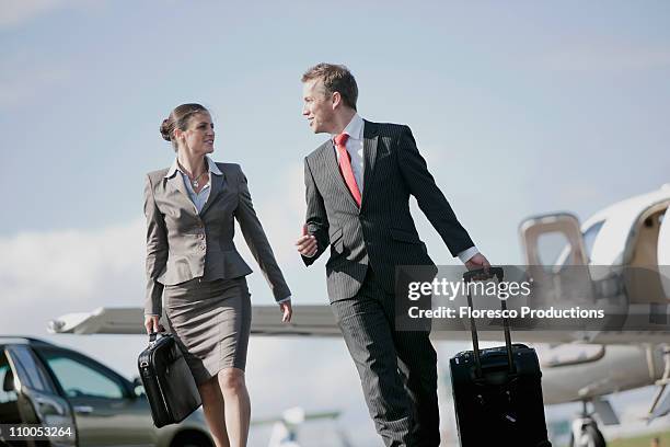 businessman and businesswoman - bristol airport stock pictures, royalty-free photos & images
