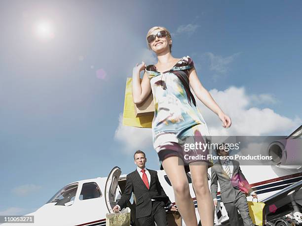 rich woman traveling in private jet - private aeroplane stock pictures, royalty-free photos & images
