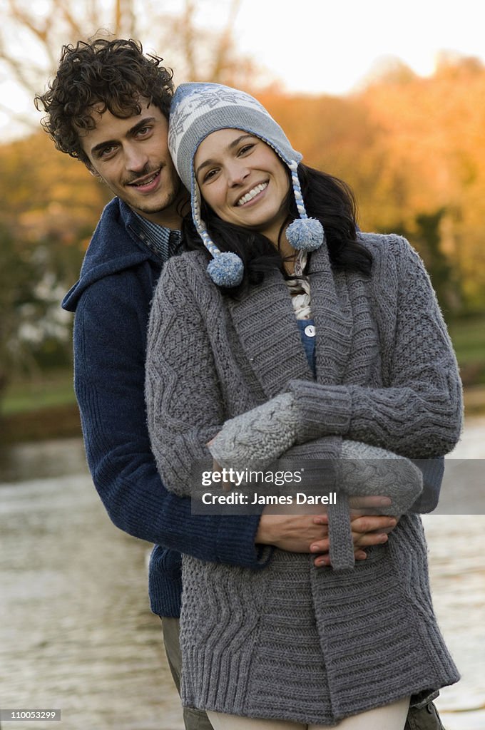 Man and woman hugging by river