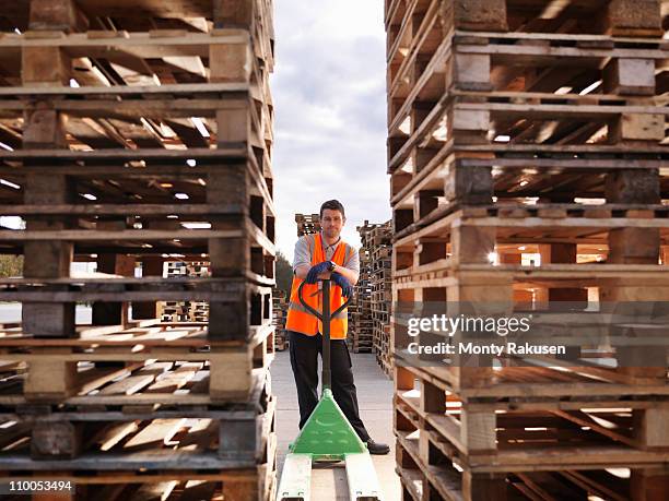 worker with pallets and pallet truck - loading bay stock pictures, royalty-free photos & images